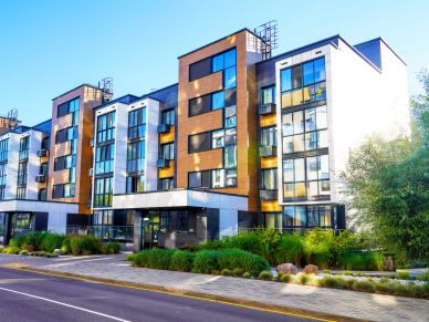 Modern multi-story residential building with large windows.