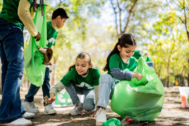 Child recyclers cleaning the public park