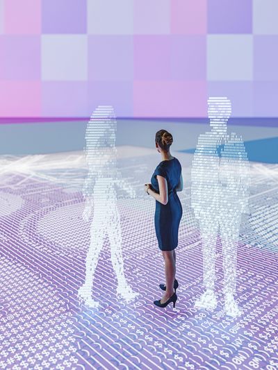 A woman stands among two digital figures made of binary code in a futuristic setting.
