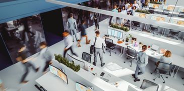 Person using laptop with futuristic virtual interface overlays.