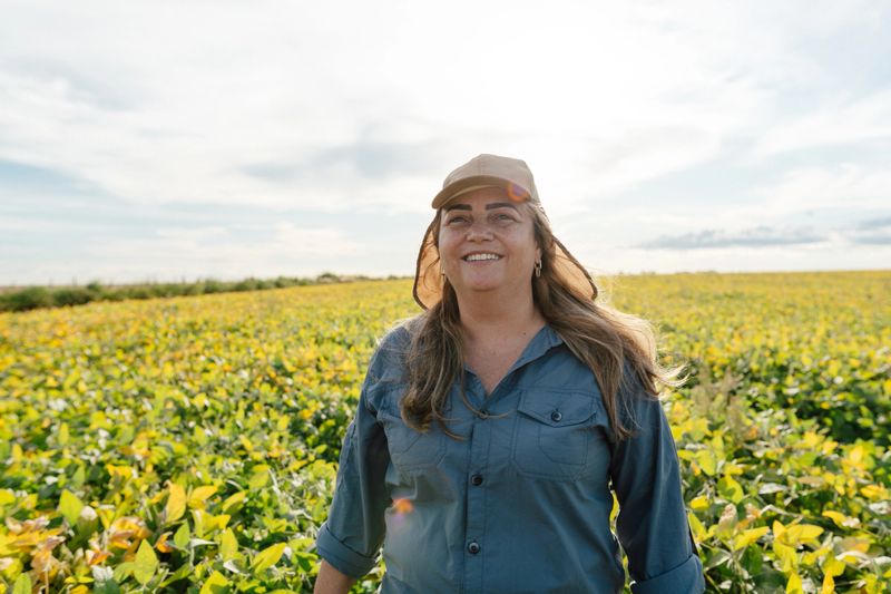 Female agronomist in yellowing soybean plantation