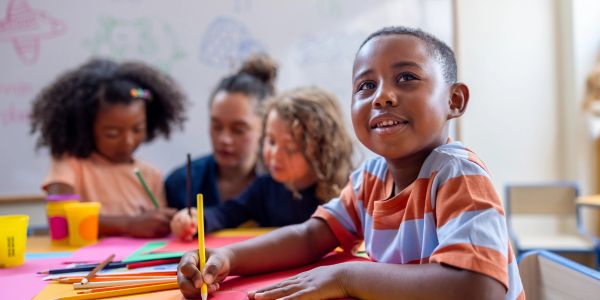 Group of children writing.