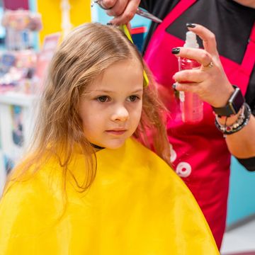little girl getting a haircut