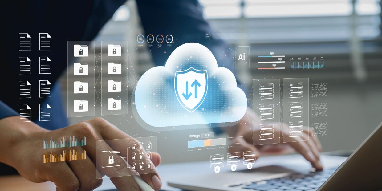 Person using laptop with digital cloud security icons.