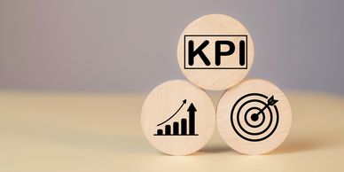 Three circles with one reading KPI, one showing a bar chart, and one showing a target