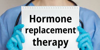 Medical professional holding a sign about hormone replacement therapy.