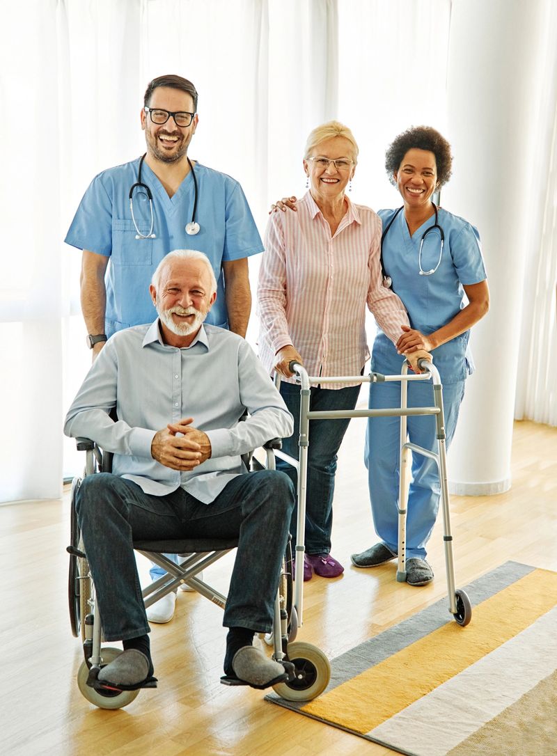 Doctor or nurse caregiver helping  senior people in a wheelchair and a walker at home or nursing home