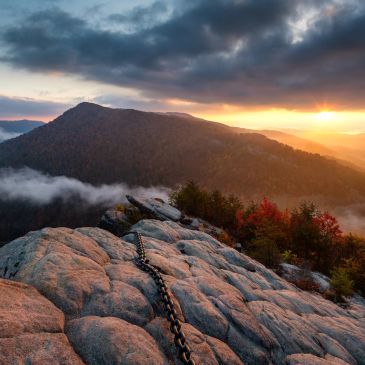 Mountain view at sunset with chain on rocks.