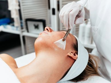 Woman receiving a facial treatment at a spa.