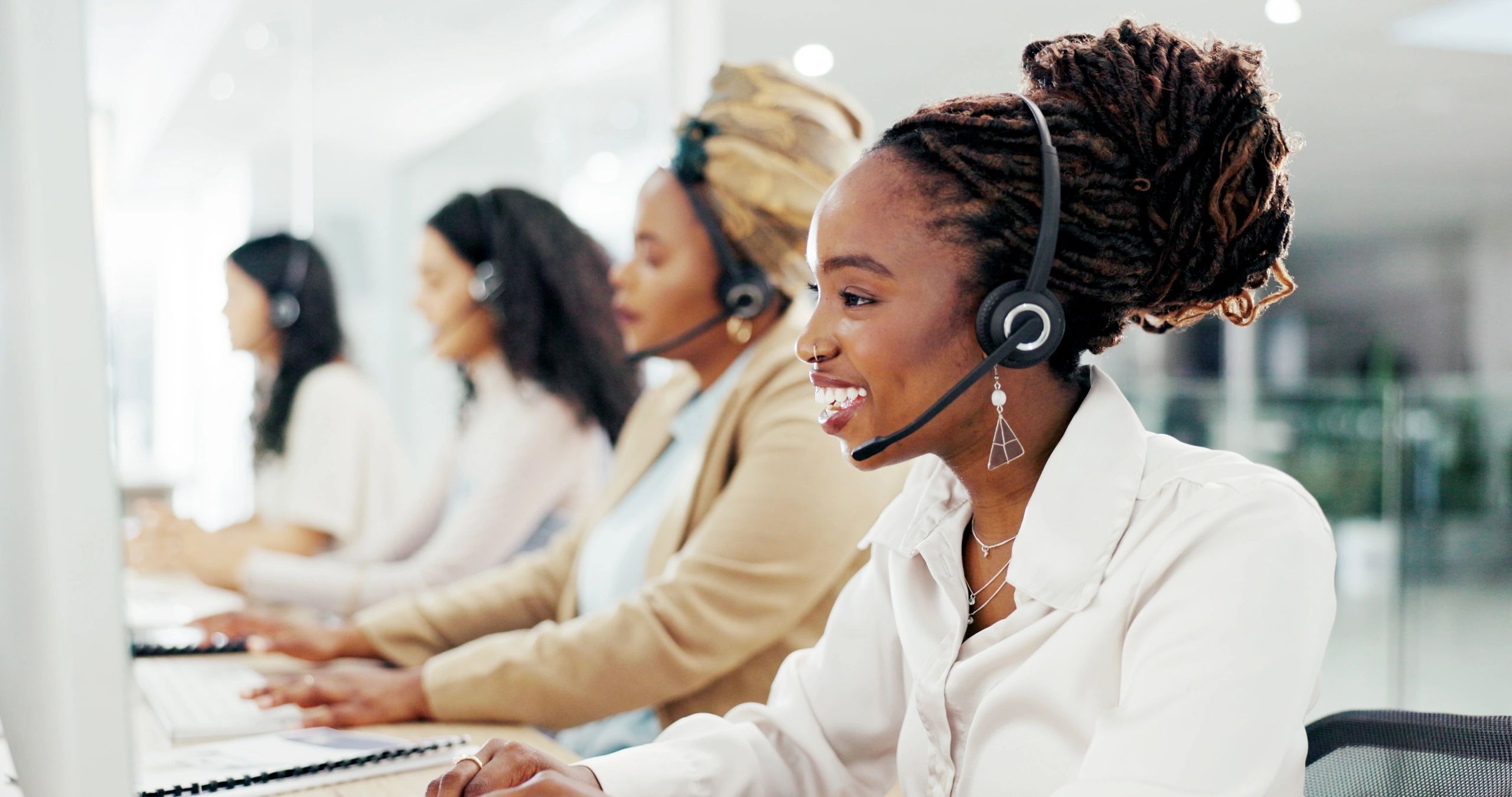 Customer service representatives working headsets