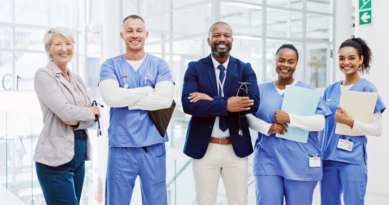 Group of diverse healthcare professionals smiling together.