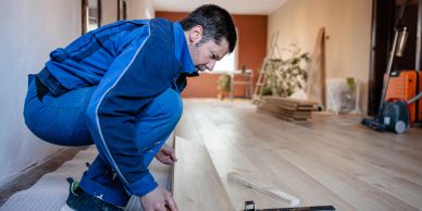Worker installing flooring.