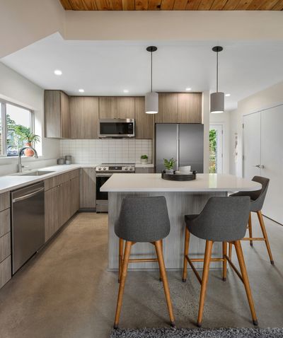 Modern kitchen remodel, concrete floors, kitchen renovation, white countertops, white backsplash