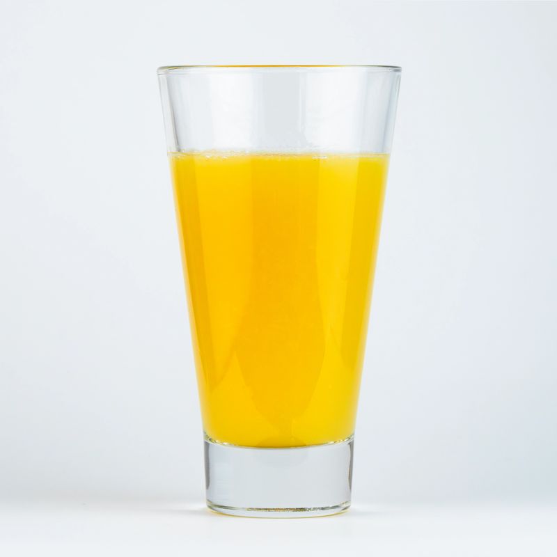 Freshly squeezed orange juice in a clear glass. High quality photo