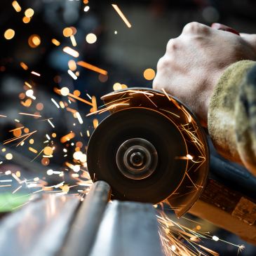 Person grinding metal with sparks flying.