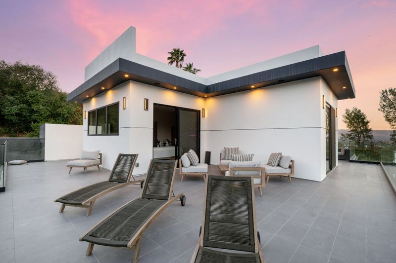 Elegant outdoor patio with stylish furniture, a private pool, and sunset views, perfect for relaxation and entertainment