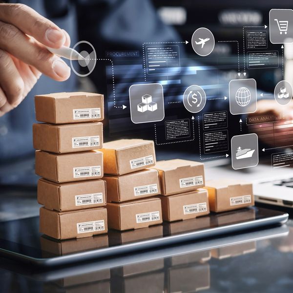 Stacked cardboard boxes with logistics icons.
