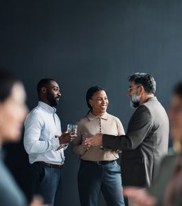 Three professionals networking and conversing.