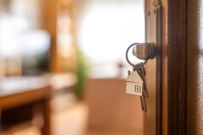 Keys with house keychain in a door lock.