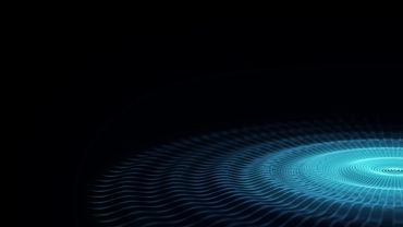 Blue digital waves forming a circular pattern on black background.