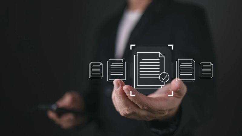 A person holds a smartphone while virtual icons of documents with a checkmark appear, symbolizing quality assurance, client focused services, and efficient document handling in a digital workflow.