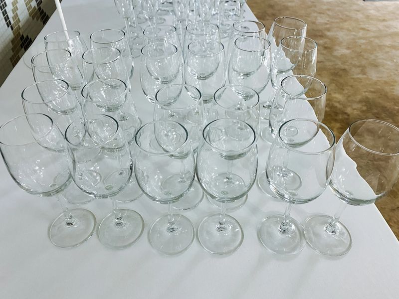 A collection of elegant wine glasses is beautifully arranged and sitting gracefully on a polished table, showcasing their exquisite design and inviting anyone to enjoy fine beverages