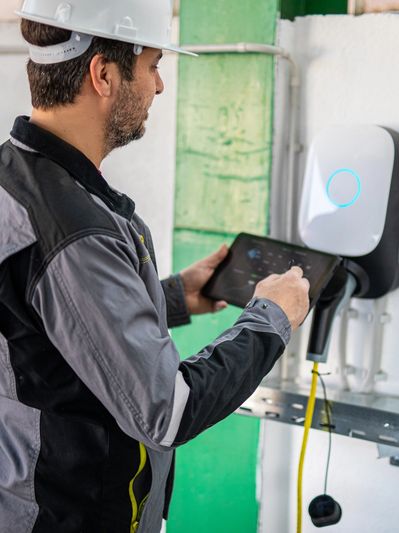 Technician operating an electric vehicle charger.