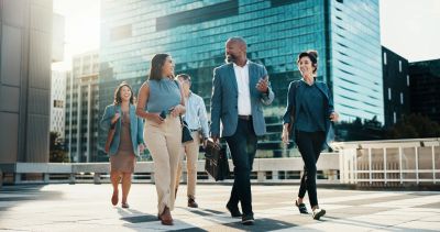 Happy business team walking in urban area.