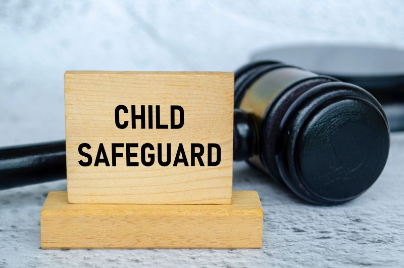 Child Safeguard text on wooden blocks with gavel background. Child safeguard concept.