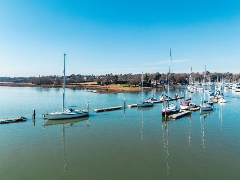 Scenic view of sailboats moored at a marina in bursledon, southampton, uk, on a bright sunny day