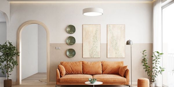 Modern living room with a cozy orange sofa and minimalist decor.