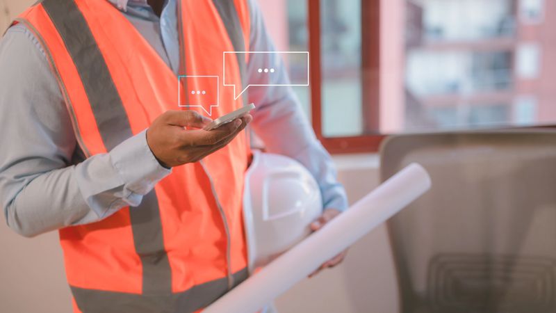 Social Media An engineer working on site using smartphone typing live chat chatting on application communication digital web and social network concept. Social media application chat box