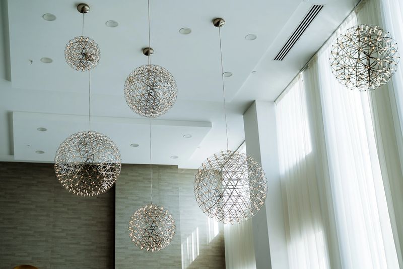 A breathtaking and stunning display of contemporary pendant lights elegantly arranged in a welllit interior space, creating an inviting and sophisticated atmosphere for all
