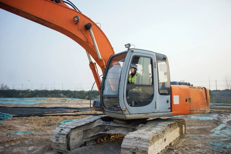 Asian female excavator driver
