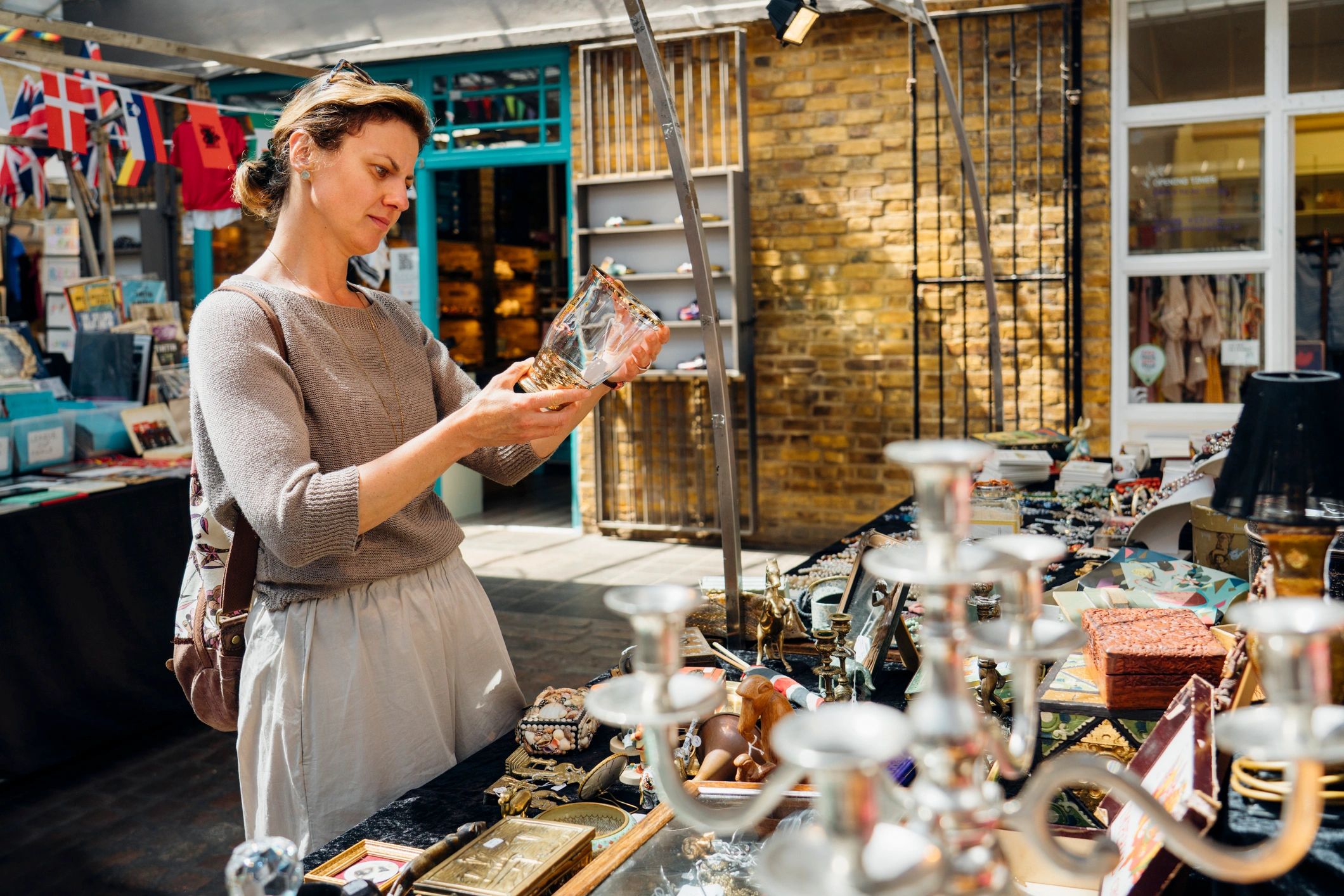 Woman examining an item at a flea market.