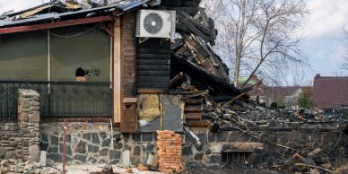 Partially destroyed house with damaged walls and roof.