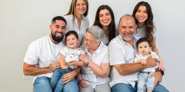 Happy multi-generational family posing together indoors.