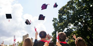Graduates tossing caps in the air.