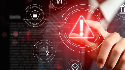 Businessman interacting with digital cybersecurity warning icons.