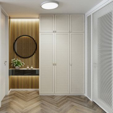 Modern hallway with wooden accents, round mirror, and built-in wardrobe.