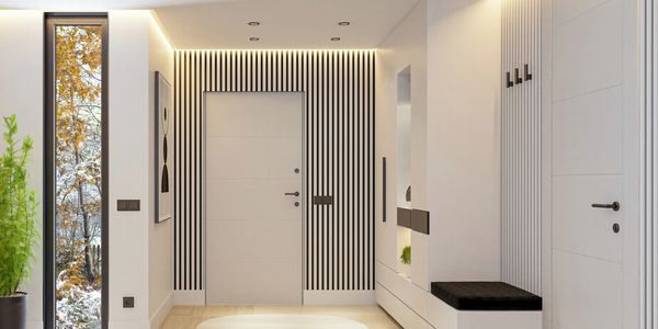 Modern hallway with striped accent wall and sleek storage bench.
