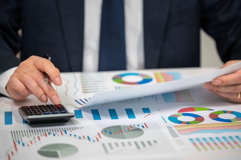 Businessman Analyzing Financial Charts and Stock Market Data