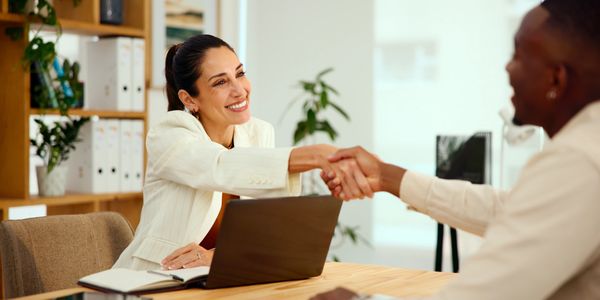 2 business people shaking hands