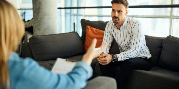 Man attentively listening during a therapy session.