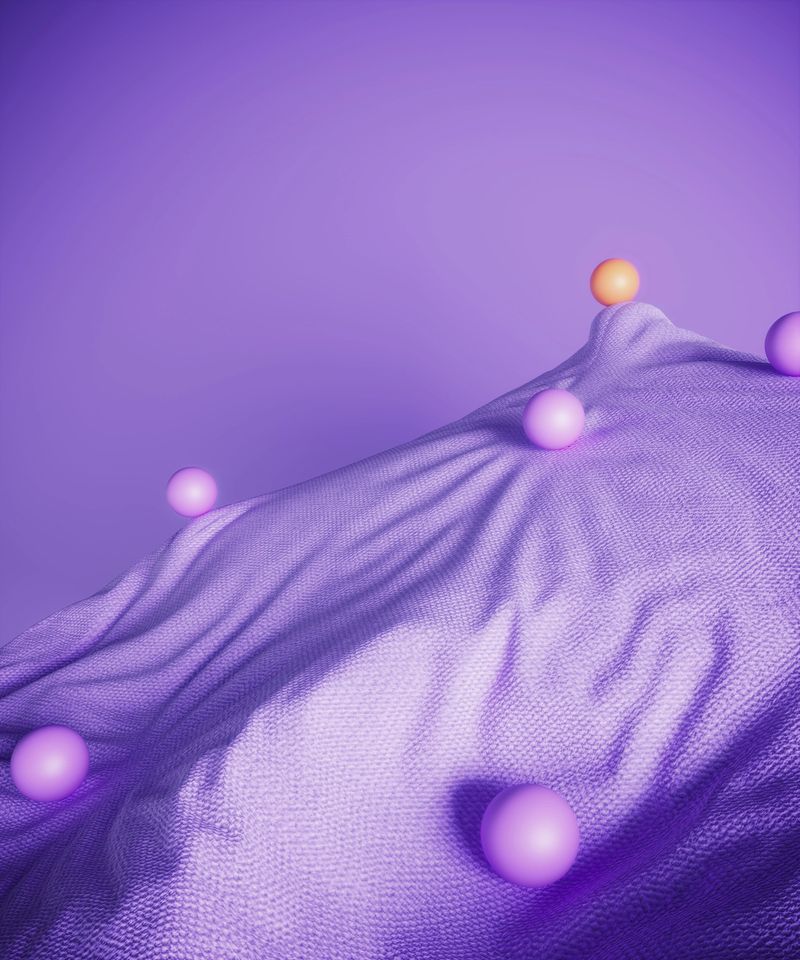 Purple spheres rolling on a purple fabric mountain, orange one on the top symbolizing teamwork, data flow, individuality concepts. (3d render)