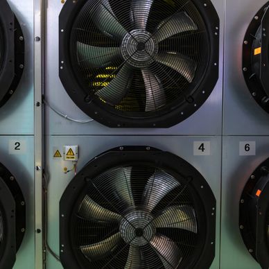 Close-up of large industrial ventilation fans numbered 2, 4, and 6.