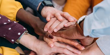Diverse hands stacked on top of each other. 
