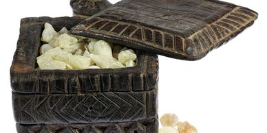 Carved wooden box filled with resin or gum crystals.