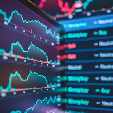 Stock market charts and buy/neutral/sell indicators on a digital screen.