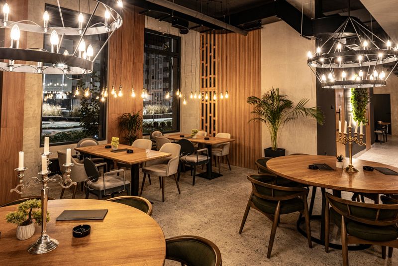 Interior of an empty restaurant at night, with modern design, nice ambient lights and decor, seating area